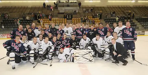 Photo By: USA Warriors Hockey The USA Warriors Hockey team poses with Army players after a game in December 2010. (USA Warriors Hockey)