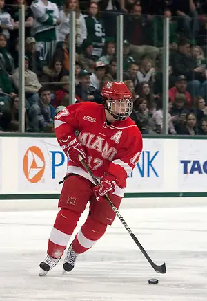 Photo By: Erica Treais Andy Miele skates up the ice with the puck. Miele scored one goal and received an assist against Michigan State.. (Erica Treais)