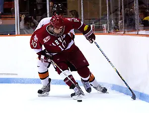 Photo By: Shelley M. Szwast Eric Kroshus (Harvard - 10) plays the puck along the boards away from Derrick Pallis (Princeton - 5). (Shelley M. Szwast)