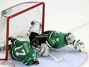 Photo By: Michelle Bishop North Dakota goalie Brad Eidsness pounces on a loose puck during the second period. Looking on is Jason Gregoire. No. 8 North Dakota used a three-goal third period to beat No. 4 UNO 6-5 Friday night at Qwest Center Omaha. (Photo by Michelle Bishop) (Michelle Bishop)