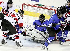 Photo By: Michelle Bishop Alabama-Huntsville goalie Clarke Saunders traps the puck under his pads as UNO's Matt Ambroz (No. 27) and Rich Purslow (No. 9) close in. Saunders finished with 58 saves. Alabama-Huntsville beat UNO 2-1 in overtime Saturday night at Qwest Center Omaha. (Photo by Michelle Bishop) (Michelle Bishop)