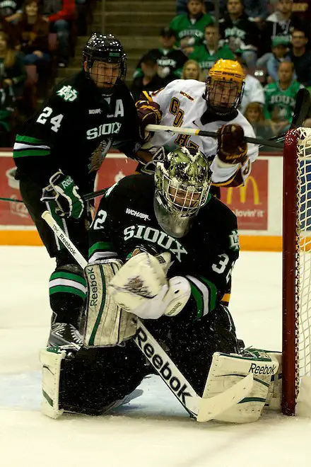 Photo By: Jim Rosvold 6 Nov 11: Ben Blood (North Dakota 24), Aaron Dell (North Dakota - 32), Erik Haula (Minnesota - 19) The University of Minnesota Golden Gophers host the University of North Dakota Fighting Sioux in a WCHA matchup at Mariucci Arena in Minneapolis, MN. (Jim Rosvold)