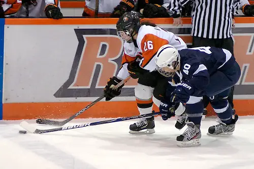 Photo By: Omar Phillips Penn State's Shannon Yoxheimer tries to poke the puck away from Kourtney Kunichika of RIT. (Omar Phillips)