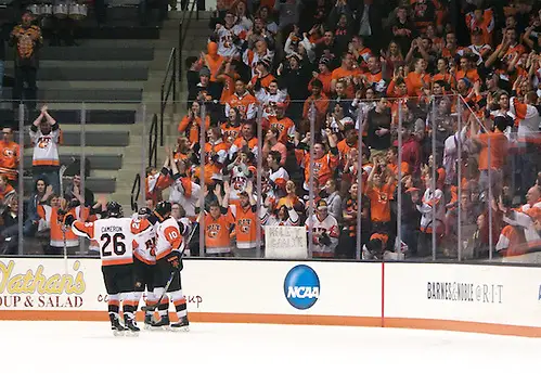Photo By: Omar Phillips RIT players and fans celebrate a first period goal by Brady Norrish (10 - RIT) (Omar Phillips)