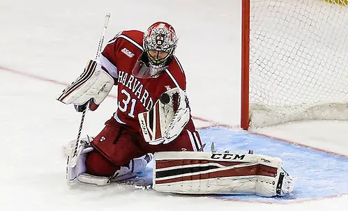 NCAA HOCKEY: MAR 19 Harvard v Quinnipiac March 19, 2016: Harvard Crimson goalie Merrick Madsen (31) watches puck as it approaches his glove during 2016 ECAC Tournament Championship game between Harvard University and Quinnipiac University at Herb Brooks Arena in Lake Placid, NY. (John Crouch/J. Alexander Imaging)