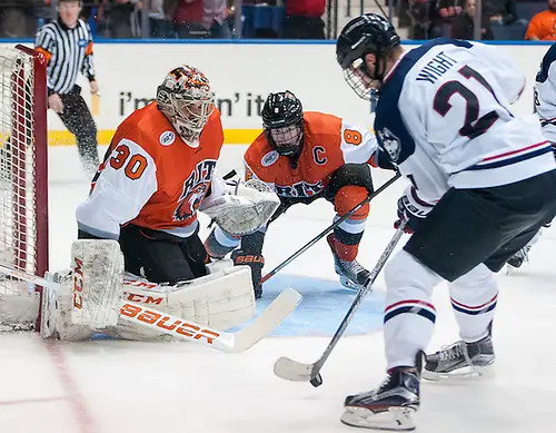 Photo By: Omar Phillips Jeff Wight (21 - UConn) tries to get a shot off on Mike Rotolo (30 - RIT) (Omar Phillips)