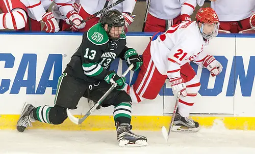 Photo By: Bradley K. Olson Mike Gornall (North Dakota-13) Patrick Harper (Boston University-21) 24 March 17 University of North Dakota and Boston University meet in the NCAA West Region at Scheels Arena Fargo, ND (Bradley K. Olson)