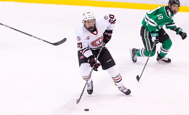 Photo By: Bradley K. Olson Will Borgen (SCSU-20) Johnny Simonson (North Dakota-10) 2017 Dec. 9 The St.Cloud State University Huskies host North Dakota in a NCHC matchup at the Herb Brooks National Hockey Center in St. Cloud, MN (Bradley K. Olson)