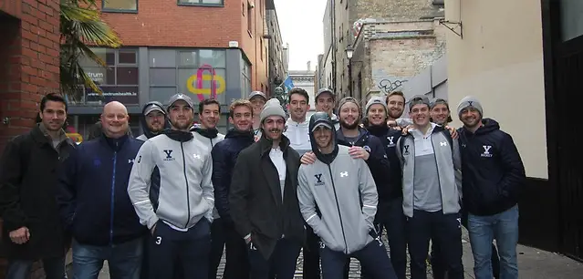 Photo By: photo: Yale Athletics Yale players take time to pose for a picture in Belfast before getting down to business on the ice Friday (photo: Yale Athletics)