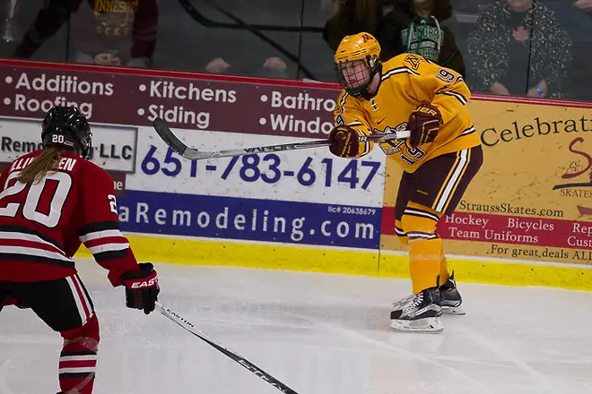 Photo By: Jim Rosvold 11 Dec 15: Suvi Ollikainan (St. Cloud -20), Kelly Pannek (Minnesota - 19). The University of Minnesota Golden Gophers play against the St. Cloud State University Huskies in the U.S. Hockey Hall of Fame Game at the Roseville Skating Center in Roseville, MN. (Jim Rosvold)