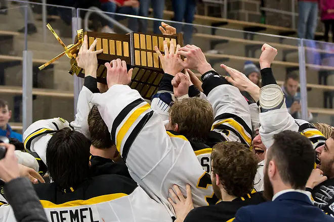 Photo By: 2019 Omar Phillips AIC players celebrate winning the 2019 Atlantic Hockey championship (2019 Omar Phillips)