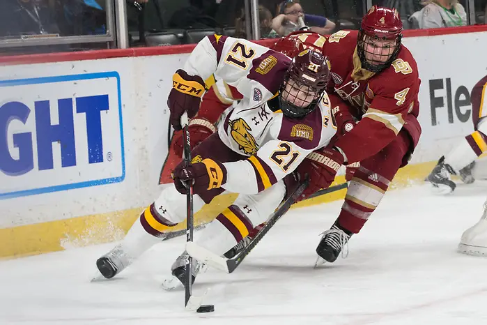 Photo By: Bradley K. Olson Noah Cates (University of Minnesota Duluth -21 ) Griffin Mendel (Denver-4) 2019 March 22 Denver and University of Minnesota Duluth meet in the semi finals of the NCHC Frozen Face Off at the Xcel Energy Center in St. Paul, MN (Bradley K. Olson)